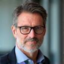 Portrait of James R, a confident tech founder in his late 40s.